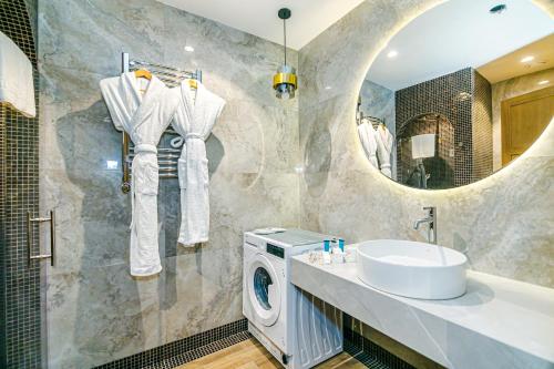 a bathroom with a sink and a washing machine at FS The Grand Sea Breeze in Baku