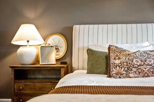 a bedroom with a bed with a lamp on a night stand at Historic Riverview Inn Three in Chattanooga