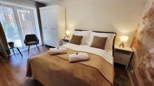 a bedroom with a large bed with two pillows on it at Calma Apartments Gattendorf in Gattendorf