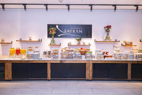 a large counter with tables and chairs on it at Wyndham Concepcion Pettra in Concepción