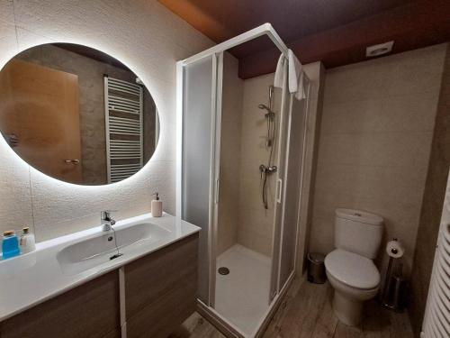a bathroom with a sink and a toilet and a mirror at Casa Rural Tarayuela in Cantavieja