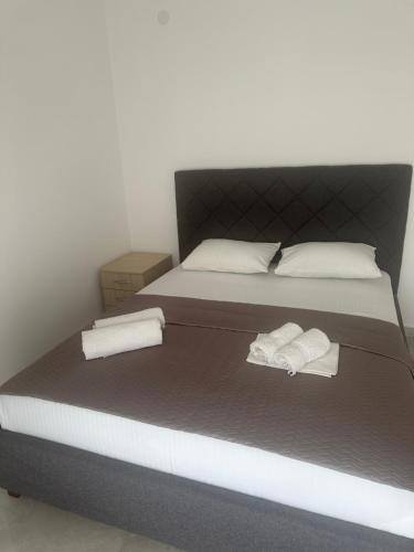 a bedroom with a bed with two towels on it at UROS apartments in Boreti