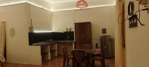 a kitchen with a table and chairs in a room at Niyati homestay in Varanasi
