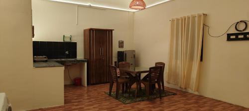 a kitchen with a table and chairs in a room at Niyati homestay in Varanasi