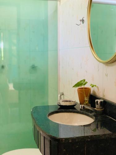 a bathroom with a sink and a mirror at Domingas in Ilha de Boipeba