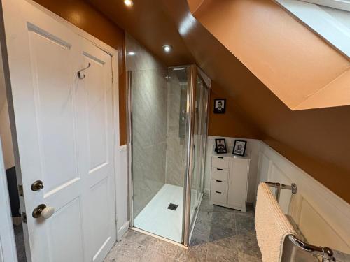 a bathroom with a shower with a glass door at The townhouse in Stornoway