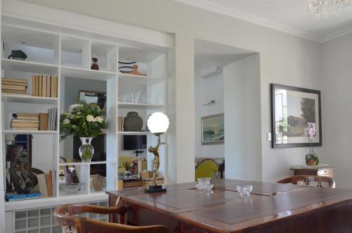 a dining room with a table and chairs at Vineyard Views Country House in Riebeek-Kasteel