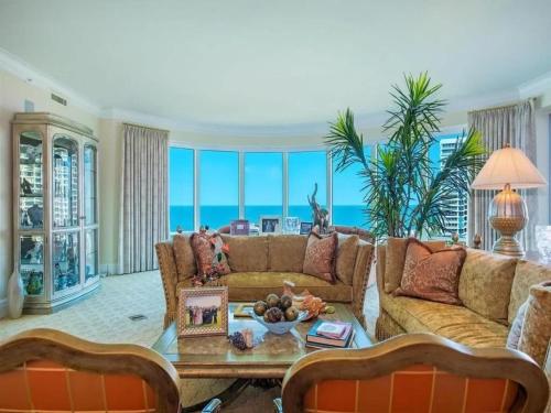 a living room with a couch and a table at Beachfront Elegance Escape in Naples