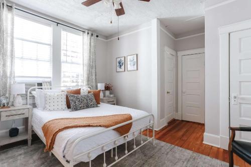 a bedroom with a bed and a window at Oglethorpe Square Historic Apt Central & Walkable in Savannah