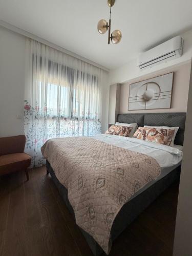 a bedroom with a large bed and a window at Harbour Light Residence in Bjeliši