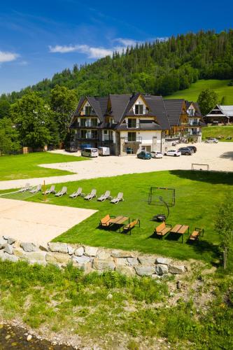 a resort with a picnic table and a playground at Grand Regle Resort & SPA in Poronin