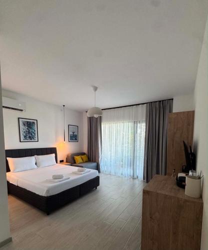 a large bedroom with a bed and a couch at Blue Breeze in Sinemorets