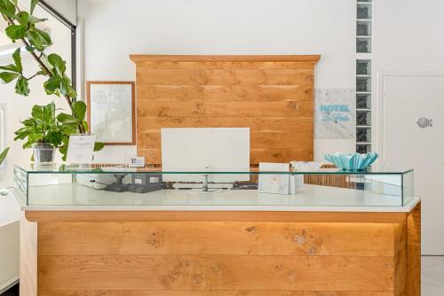 a glass desk in a room with a wooden wall at Hotel La Perla in Marina di Massa