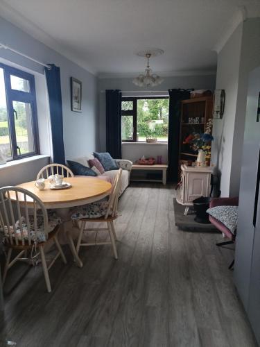 a living room with a table and a couch at Cistin Bheag Áine in Ballygawley