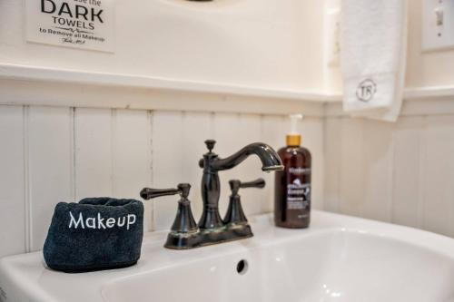 a sink with a bottle of soap and a soap holder at Historic Riverview Inn Six in Chattanooga