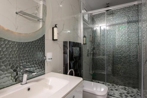 a bathroom with a sink and a shower at Villa Andriana in Panagia