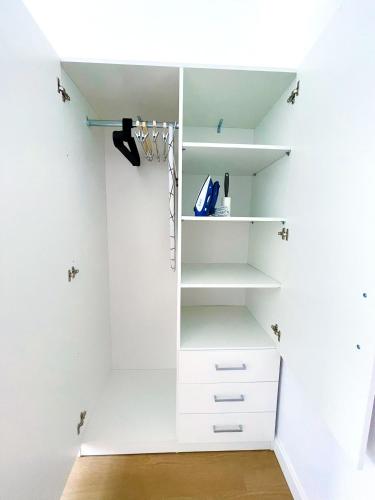a white walk in closet with white shelves at Casa Cachú in Baiona