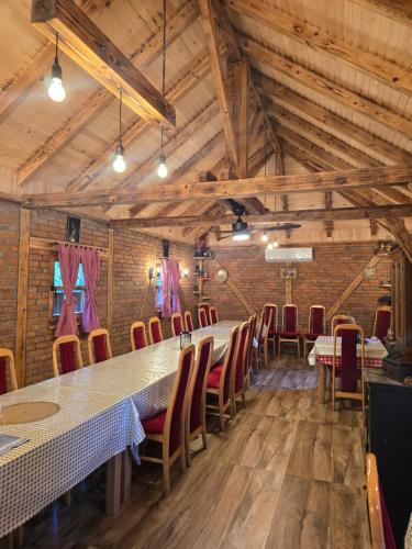 a dining room with a long table and chairs at Forest soul "Jaslice" - Ozren in Doboj