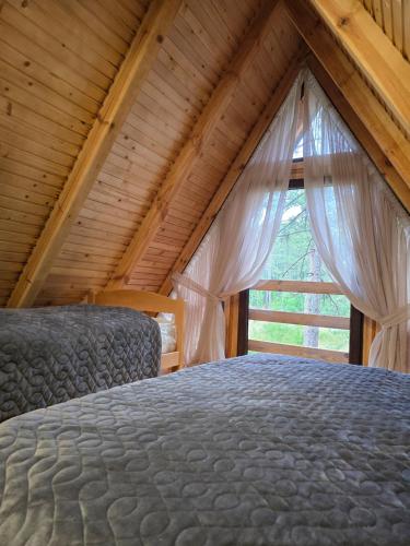 a bedroom with a bed and a window at Forest soul "Jaslice" - Ozren in Doboj
