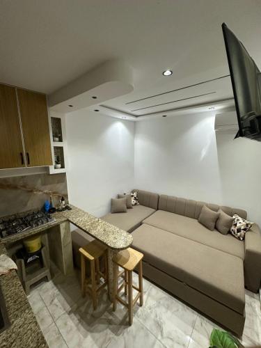 a living room with a couch and a table at 1-bedroom apartment in Monastir