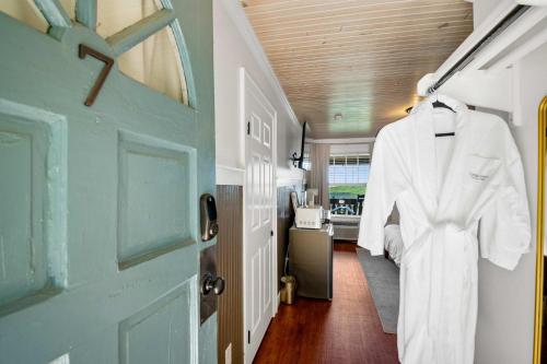 a white robe hanging on a door in a hallway at Historic Riverview Inn Seven in Chattanooga