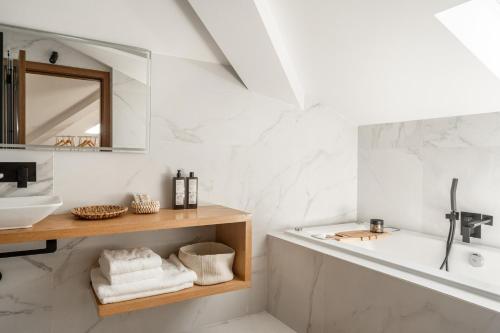 a bathroom with a sink and a bath tub at Vila das Acácias - Boutique Villa in Wine Country in Alenquer