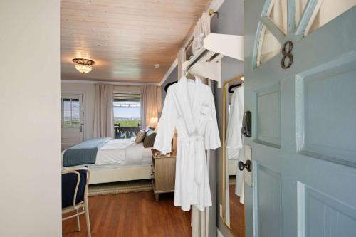 a white robe hanging on a door in a bedroom at Historic Riverview Inn Eight in Chattanooga