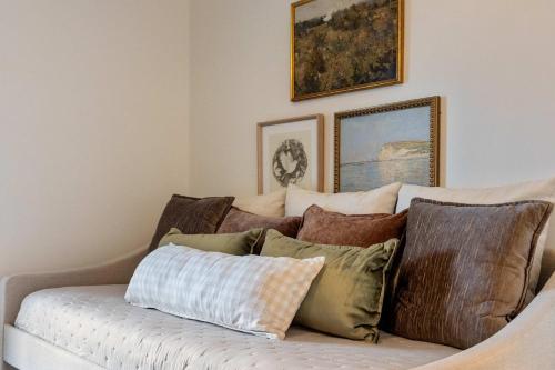 a couch with a bunch of pillows on it at Historic Riverview Inn Suite Ten in Chattanooga