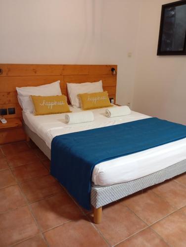 a bedroom with a large bed with a blue blanket at coconut beach citerne marisol in Le Gosier