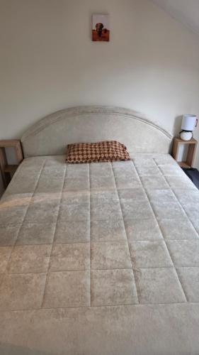 a large bed in a room with at Safari Luštica in Luštica