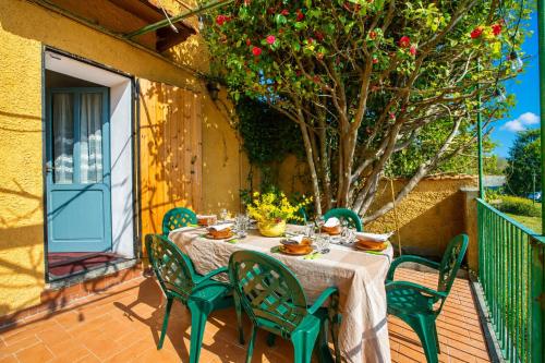 a table and chairs on a patio with a tree at Villa I Tre Archi for 6 with Private Garden - Happy Rentals in Pisano