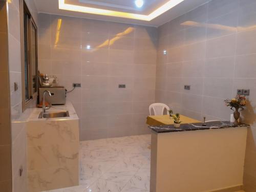 a bathroom with a sink and a mirror at Relax House 2 in Al Massira Airport