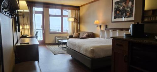 a hotel room with a bed and a balcony at Canal Park Lodge in Duluth