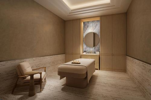 a room with a table and a chair and a mirror at Jakarta Marriott Hotel Gelora in Jakarta