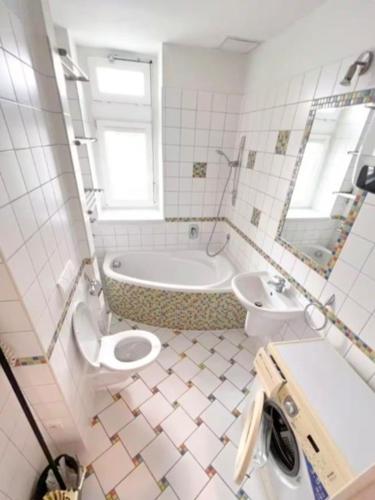 a bathroom with a toilet and a tub and a sink at Solaris in Ostrava