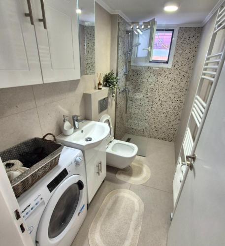 ein Badezimmer mit Waschmaschine und Toilette in der Unterkunft Centro casa in Arta