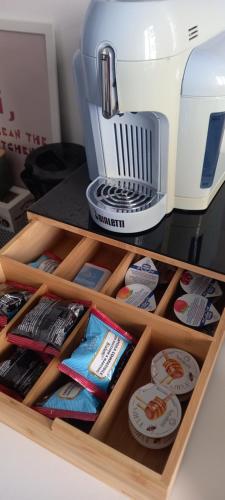 a wooden drawer with food and a coffee maker at Casa Teresa in Rome