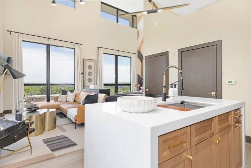 a kitchen with a sink and a living room at The Eighth Luxury Penthouse in Fourth Ward in Charlotte