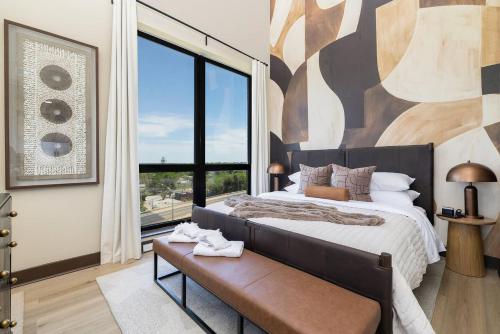 a bedroom with a large bed and a large window at The Eighth Luxury Penthouse in Fourth Ward in Charlotte