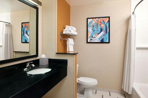 a bathroom with a sink and a toilet and a mirror at Fairfield Inn & Suites by Marriott Stafford Quantico in Stafford