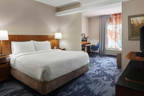 a hotel room with a bed and a desk at Fairfield Inn & Suites by Marriott Stafford Quantico in Stafford