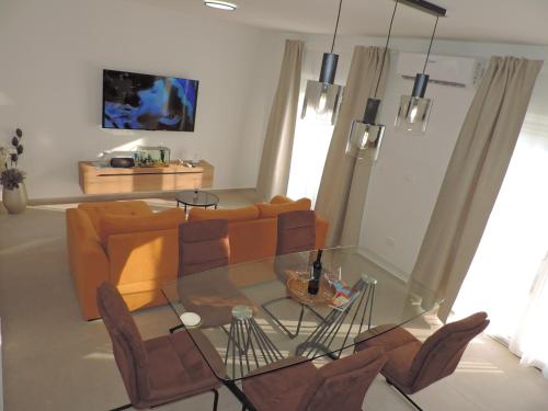 a living room with a glass table and a couch at Villa RoseMary in Split
