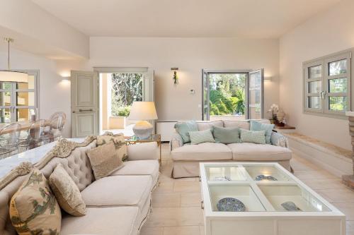 a living room with a couch and a table at Apelia Estate - Among Ancient Olives, Experience the Quiet Soul of Corfu in Corfu