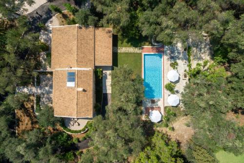 an aerial view of a house with a swimming pool at Apelia Estate - Among Ancient Olives, Experience the Quiet Soul of Corfu in Corfu