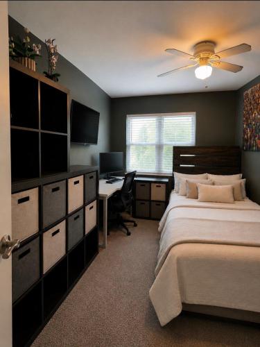 a bedroom with a bed and a desk with a computer at Matt Cozy Quarters in Orangeburg