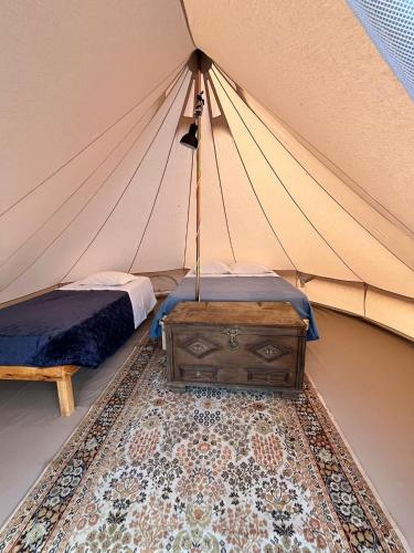 a bedroom in a tent with a bed and a table at LOUSAL TENTS Grandola in Lousal
