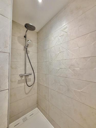 a shower with a shower head in a bathroom at Bed & Breakfast L'Etape Basque in Bidart
