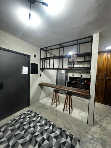 a kitchen with a wooden table in a room at FLAT PALLADIUM - de frente in São Vicente