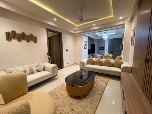 a living room with two couches and a coffee table at Designer Boutique Hotel Serviced Apartments Bahria Town Islamabad & Rawalpindi - LMY in Rawalpindi