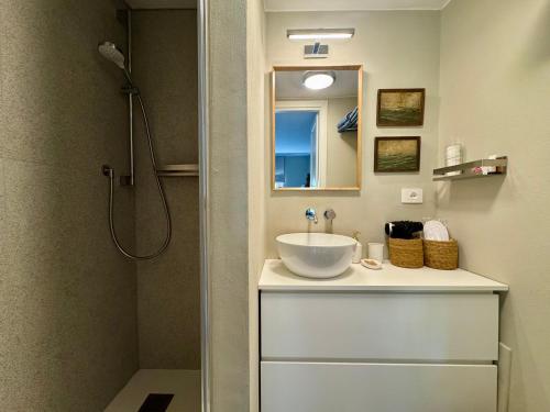 a bathroom with a sink and a shower at La Casetta in riva al mare in Quercianella